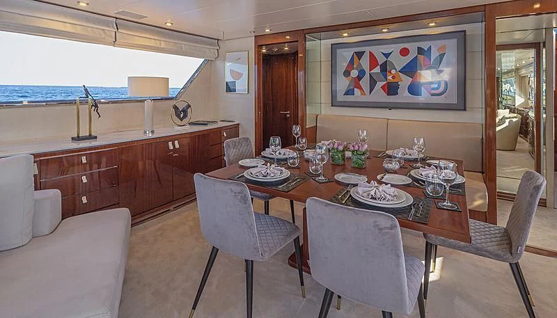 a dining room with a table and chairs aboard GRACE Yacht for Sale