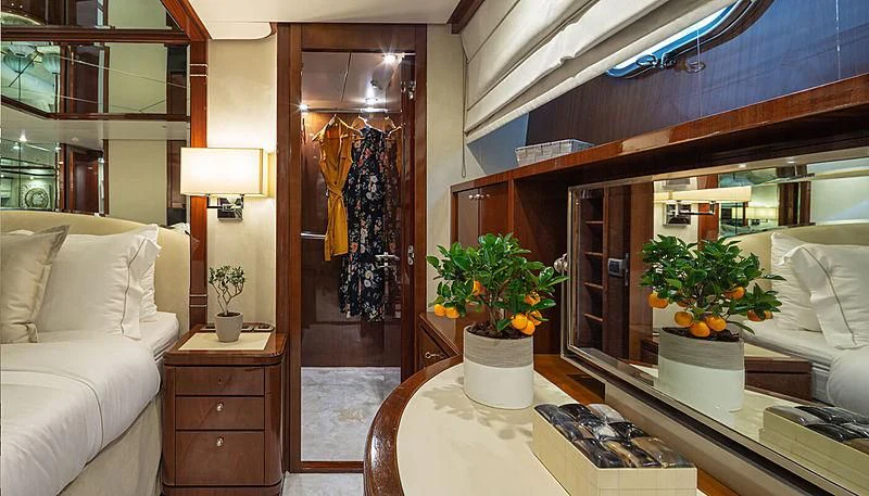 a room with a table and a couch and a plant in a pot aboard GRACE Yacht for Sale