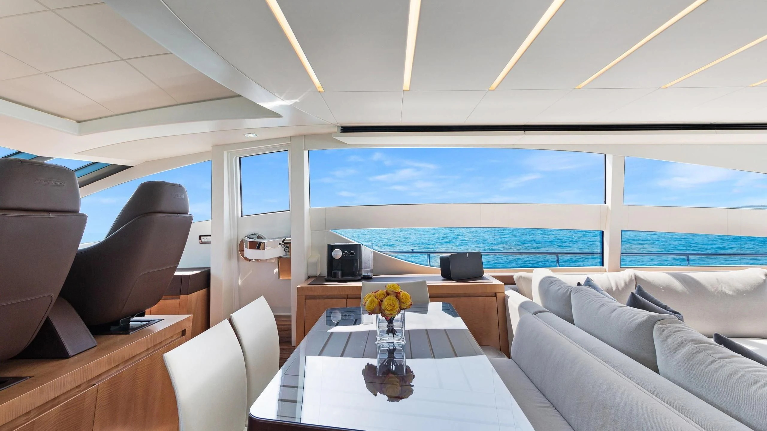 inside of a room with a table and chairs and a large window aboard VIXEN Yacht for Sale