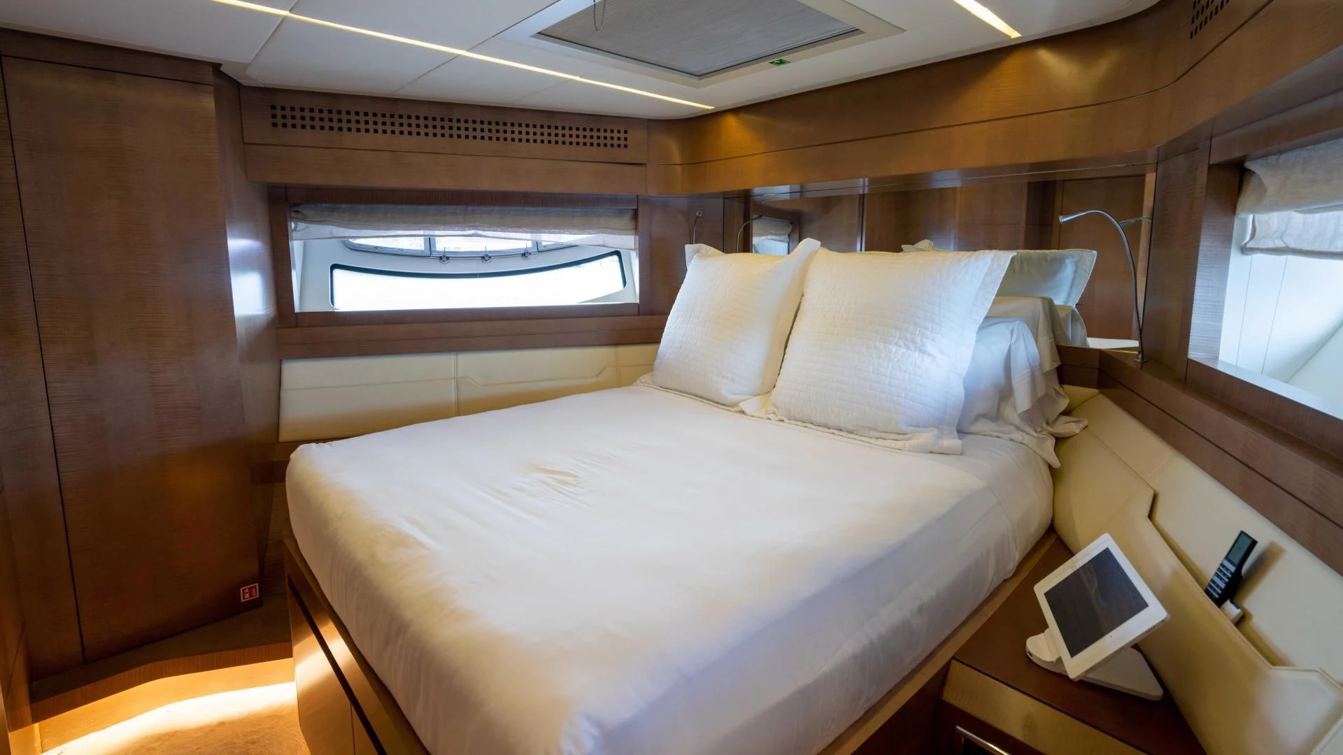 a room with a bed and a laptop on a table aboard VIXEN Yacht for Sale