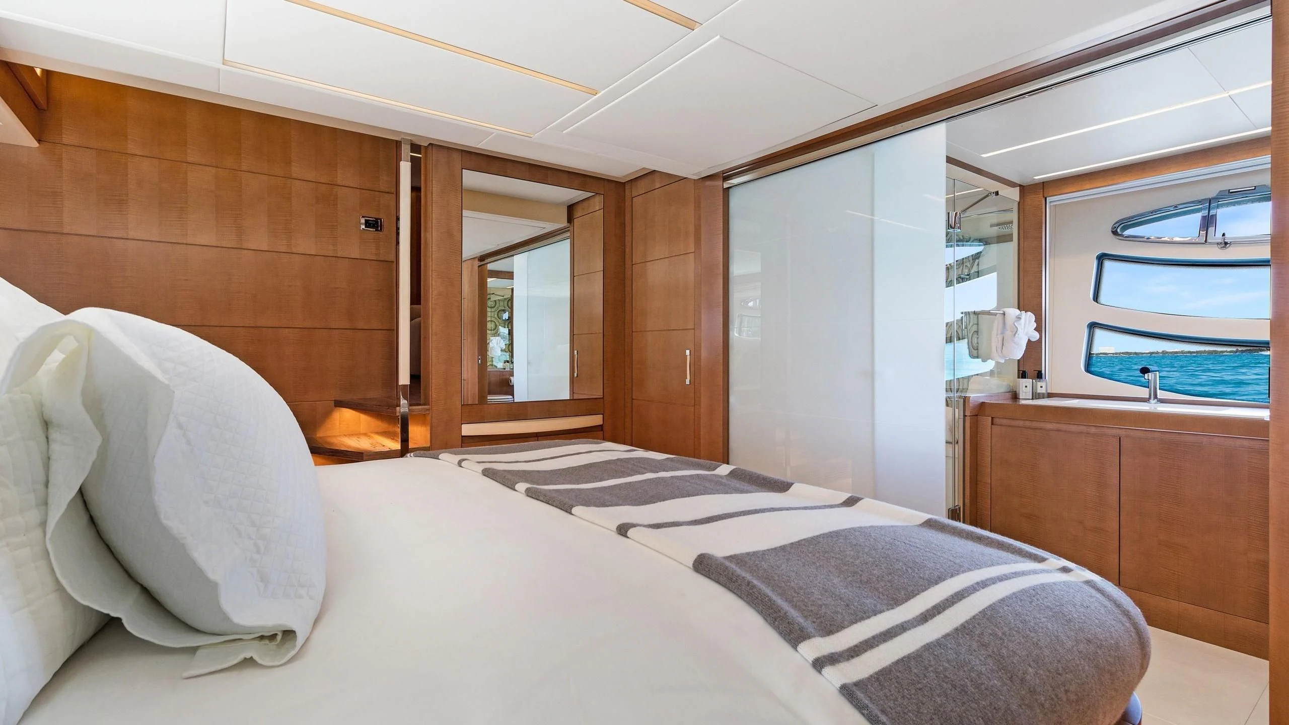 a room with a bed and a window aboard VIXEN Yacht for Sale