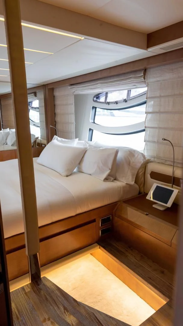 a bed with a laptop on it aboard VIXEN Yacht for Sale