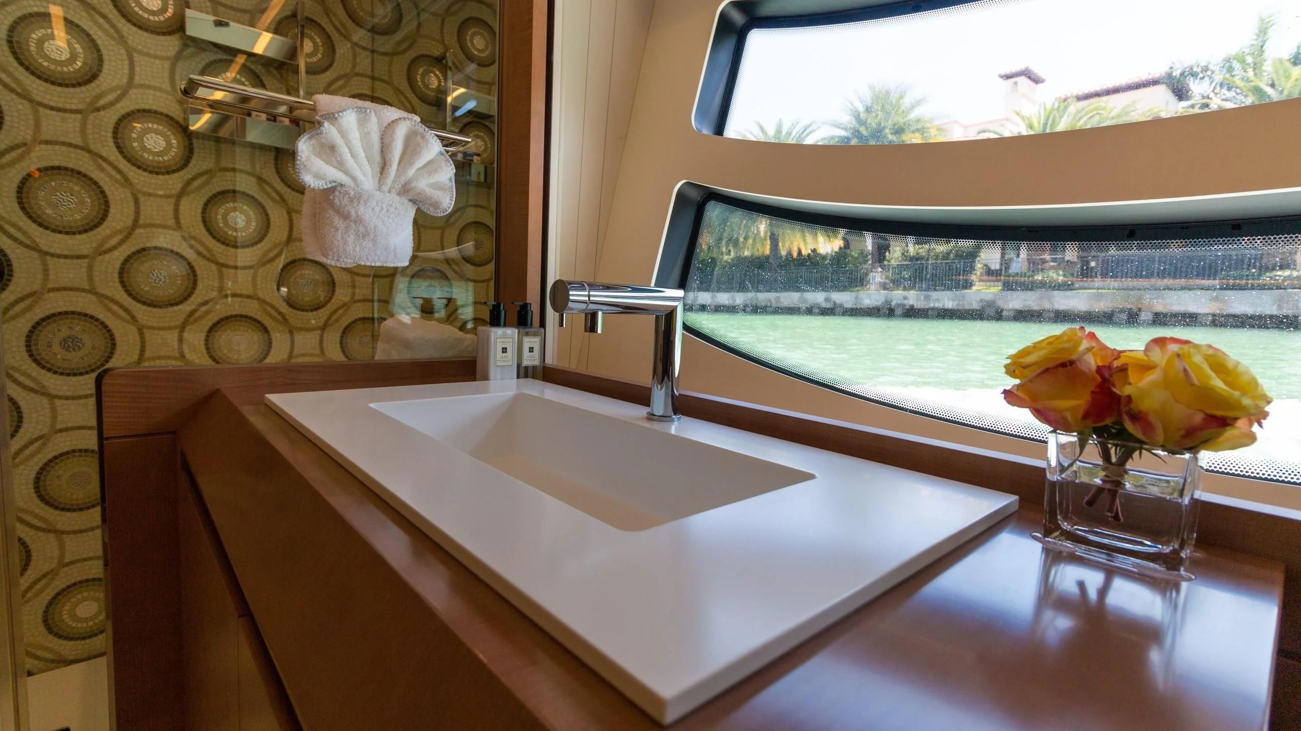 a bathtub with flowers in a room with a window aboard VIXEN Yacht for Sale
