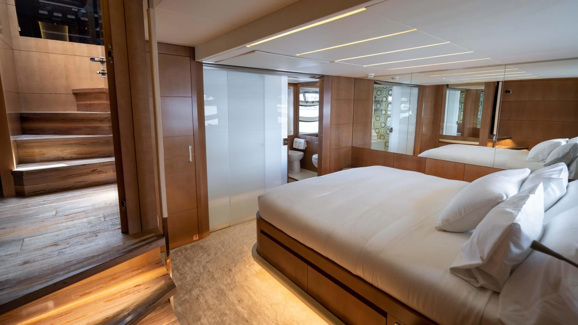 a large bedroom with a wood floor aboard VIXEN Yacht for Sale