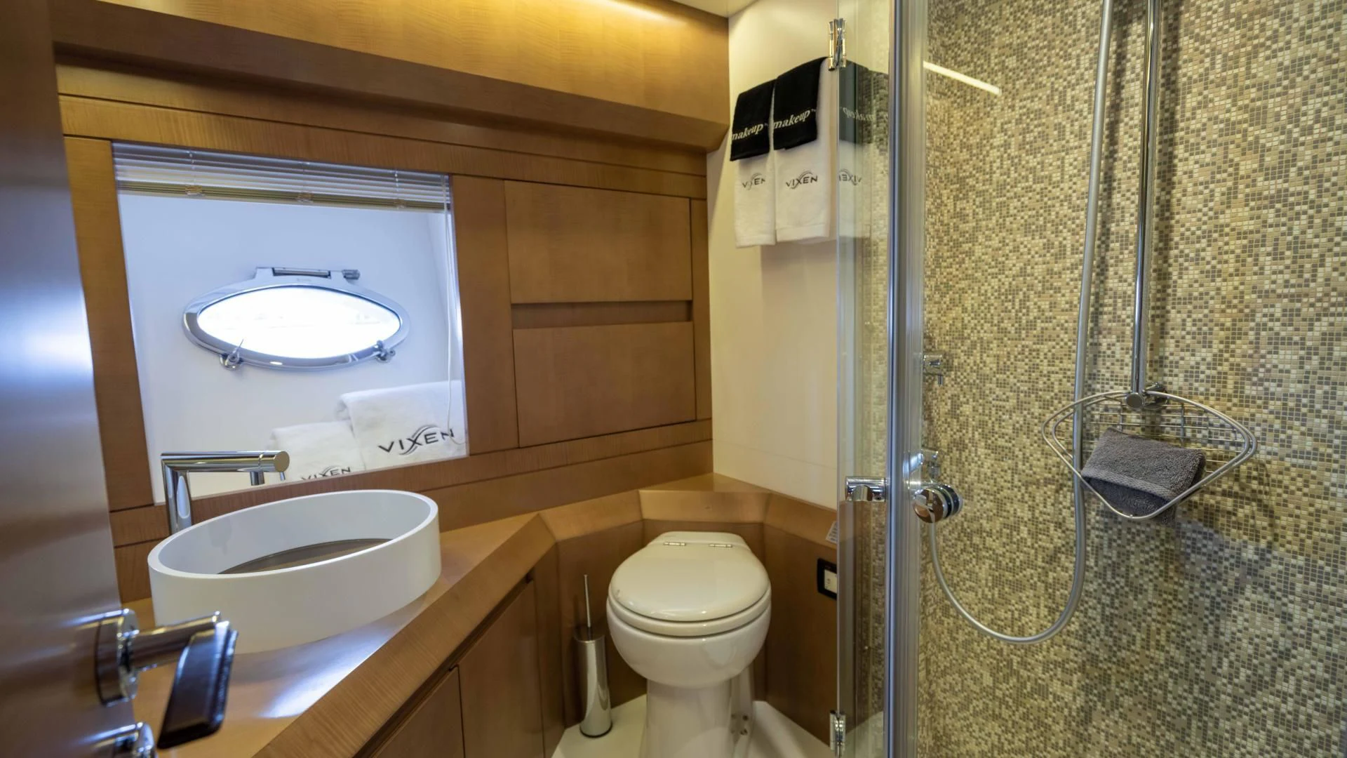 a bathroom with a sink toilet and a mirror aboard VIXEN Yacht for Sale