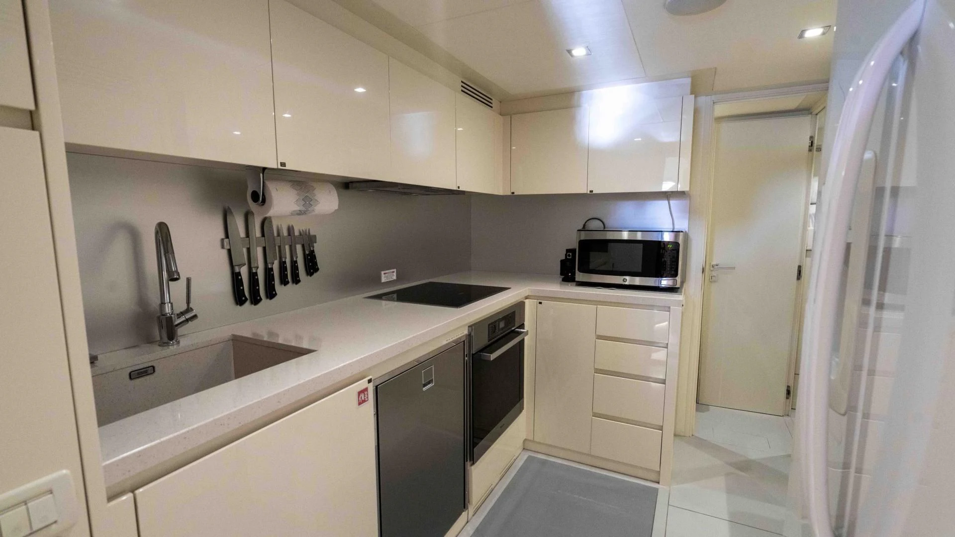 a kitchen with white cabinets aboard VIXEN Yacht for Sale
