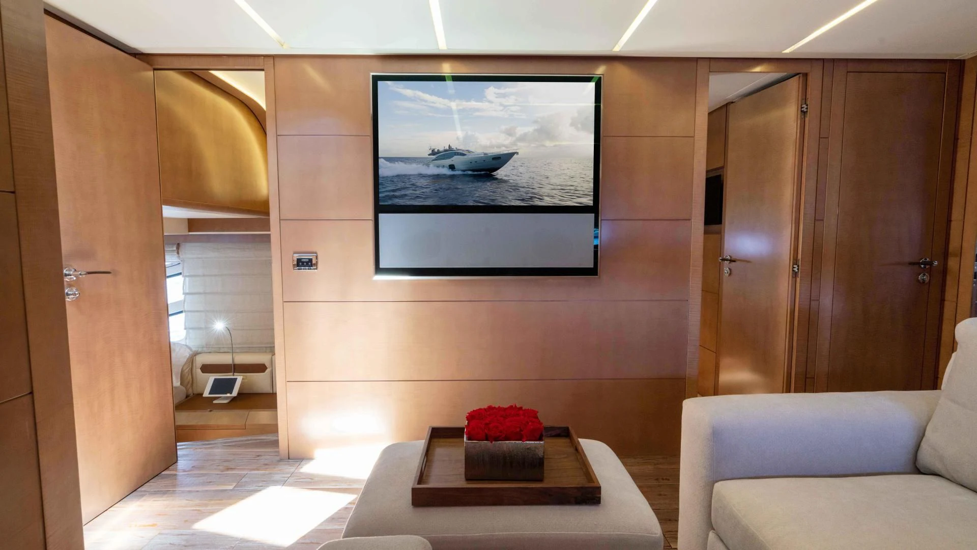 a room with a couch and a tv on the wall aboard VIXEN Yacht for Sale