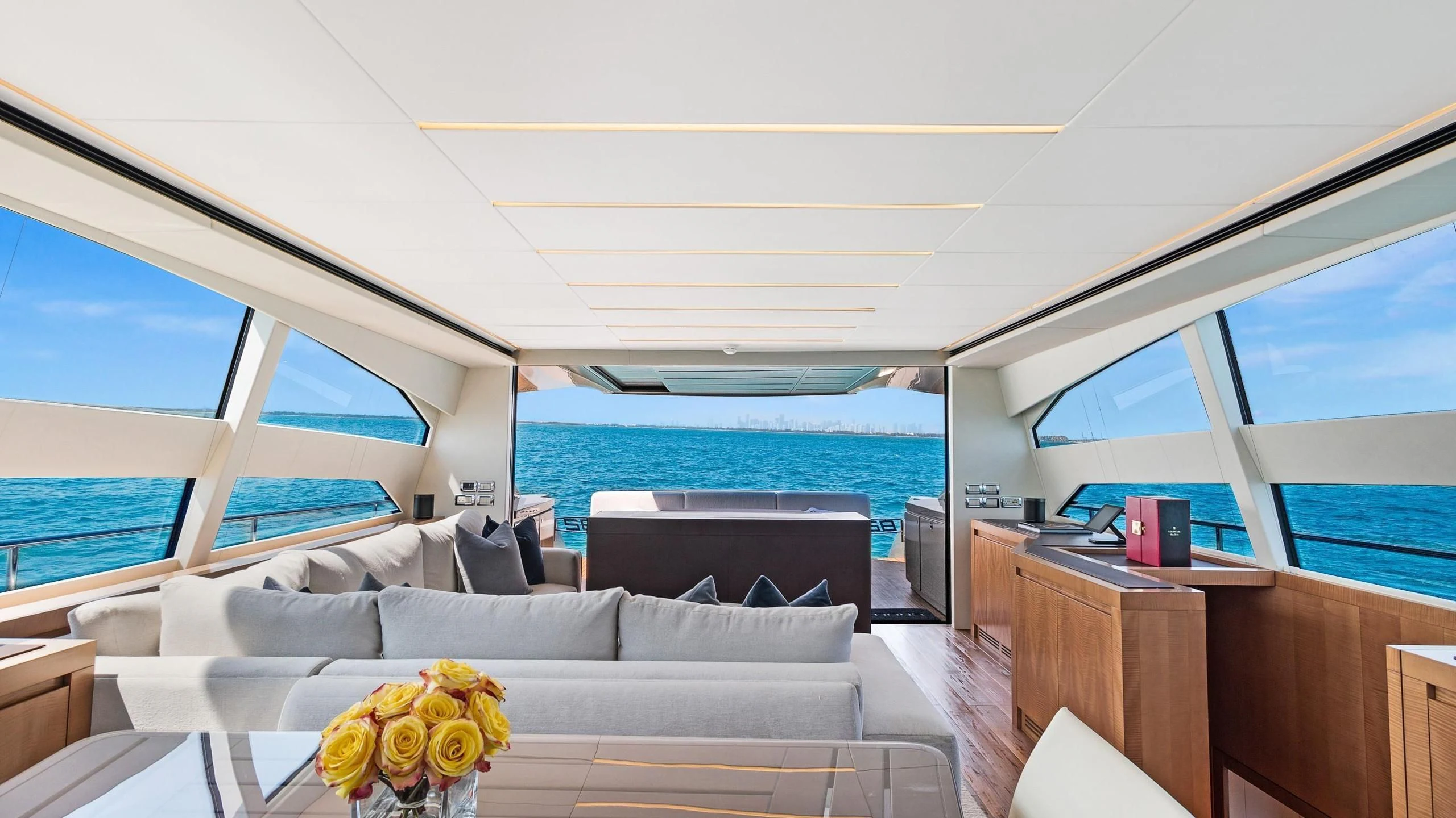 a room with a couch and a table with a view of the ocean aboard VIXEN Yacht for Sale