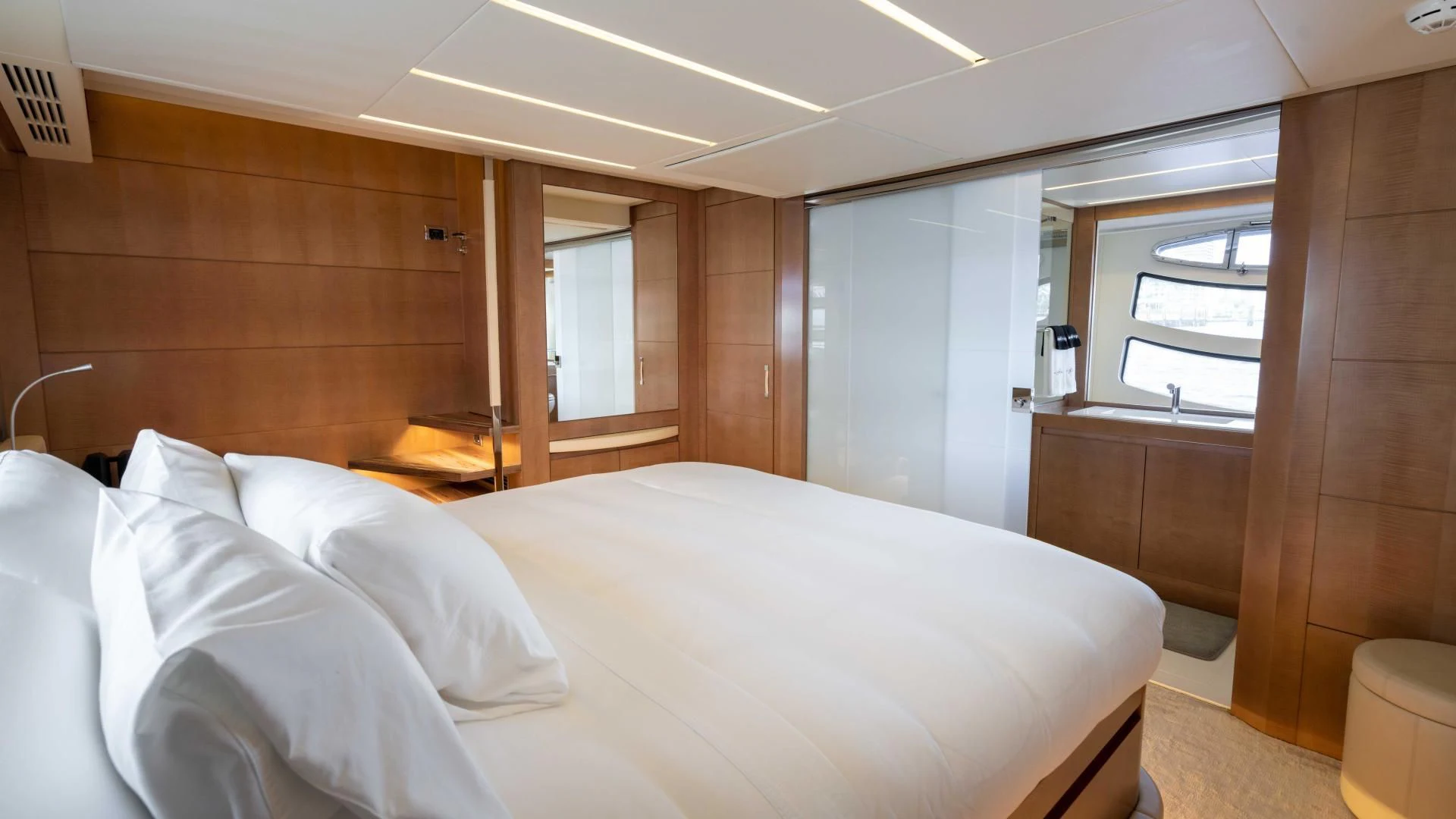 a room with a bed and a window aboard VIXEN Yacht for Sale