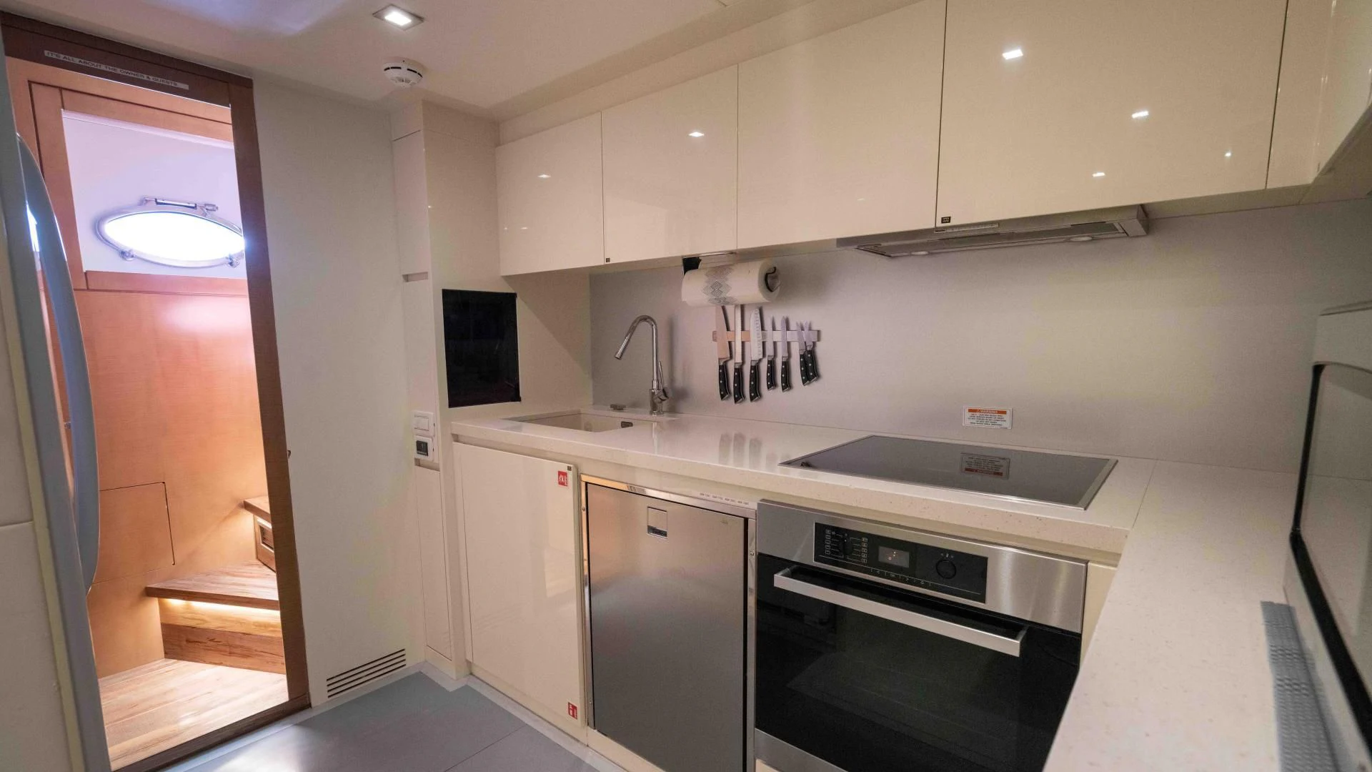 a kitchen with white cabinets aboard VIXEN Yacht for Sale