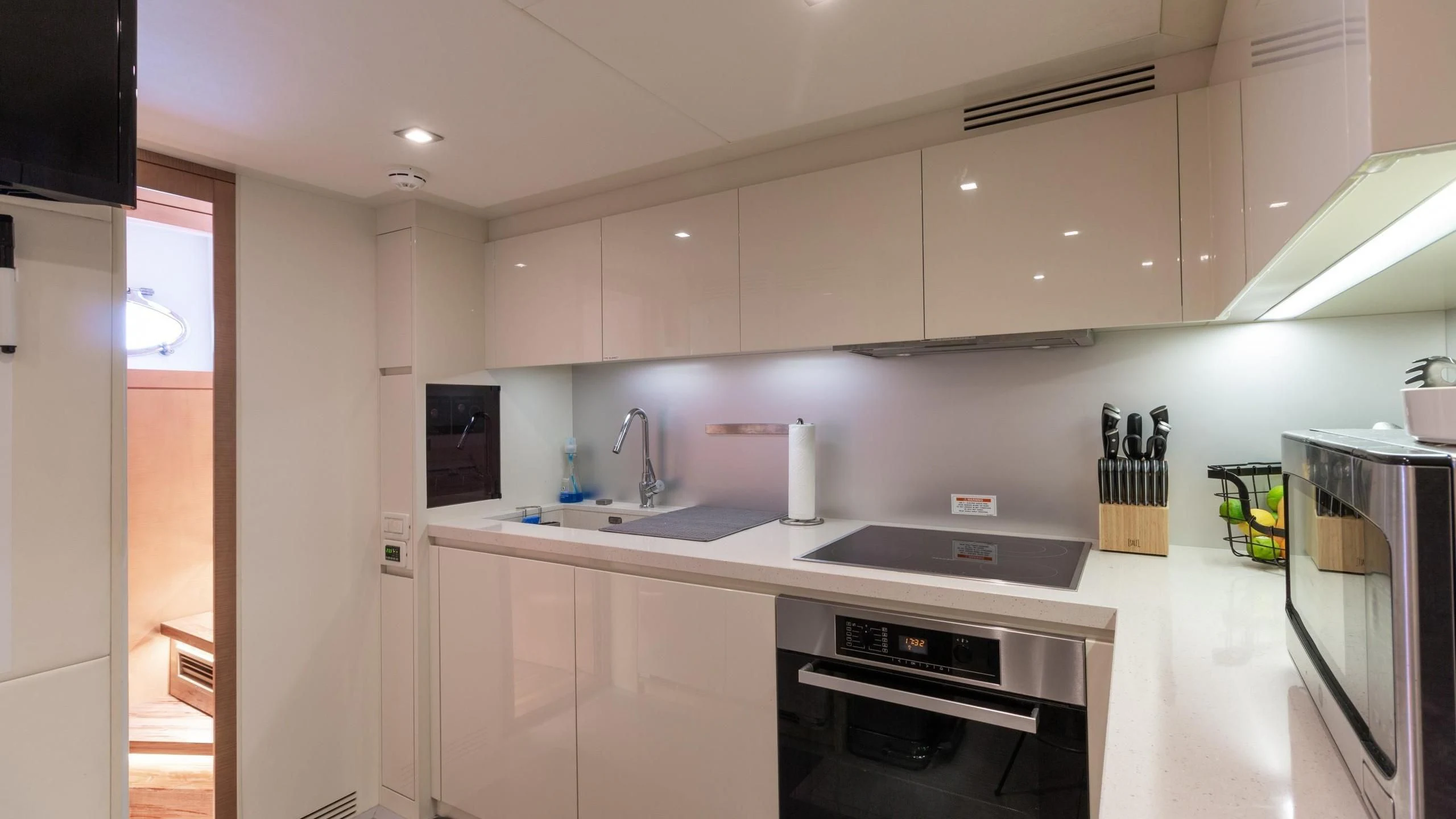 a kitchen with white cabinets aboard VIXEN Yacht for Sale