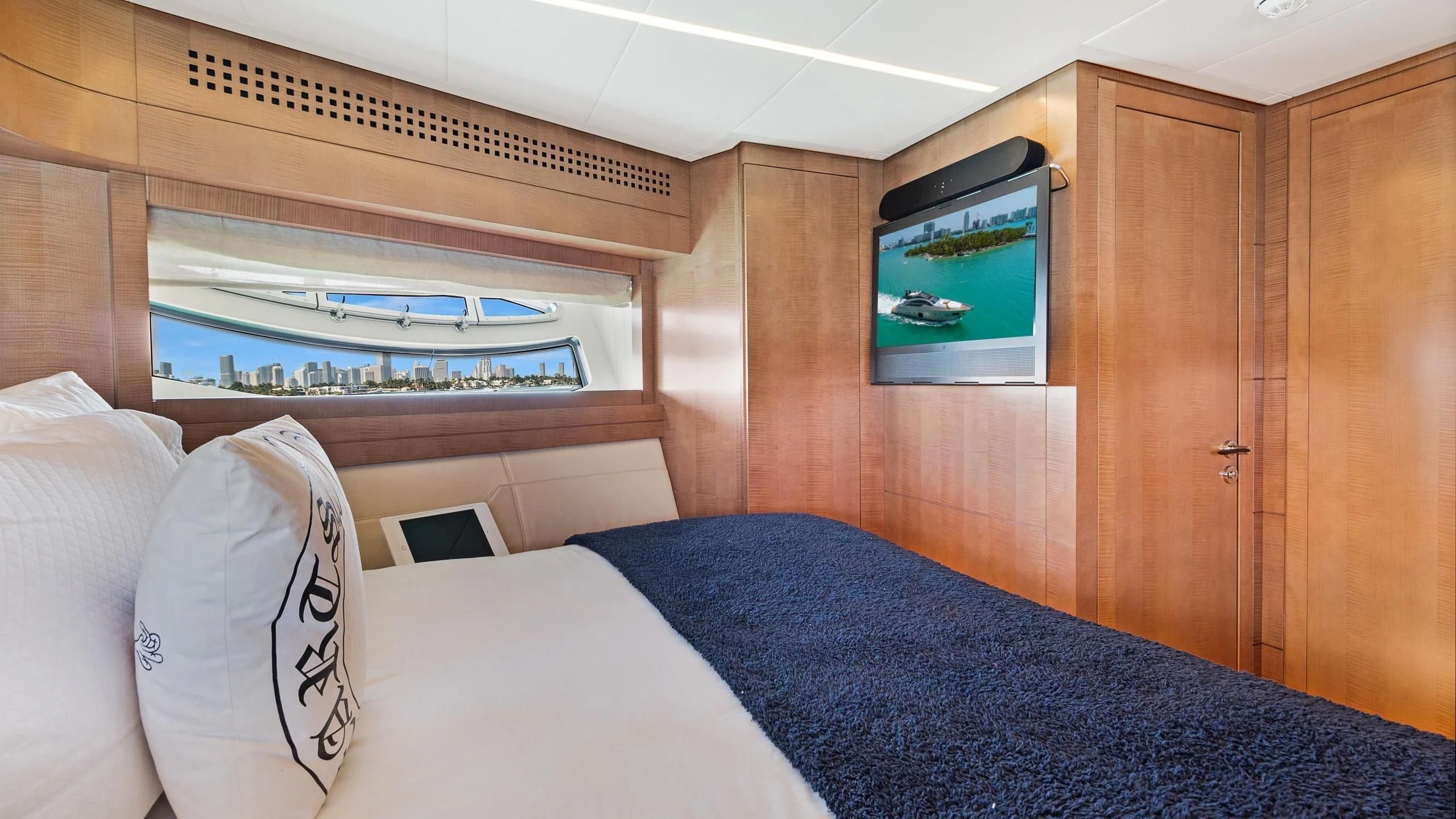 a bed with a television on the wall aboard VIXEN Yacht for Sale