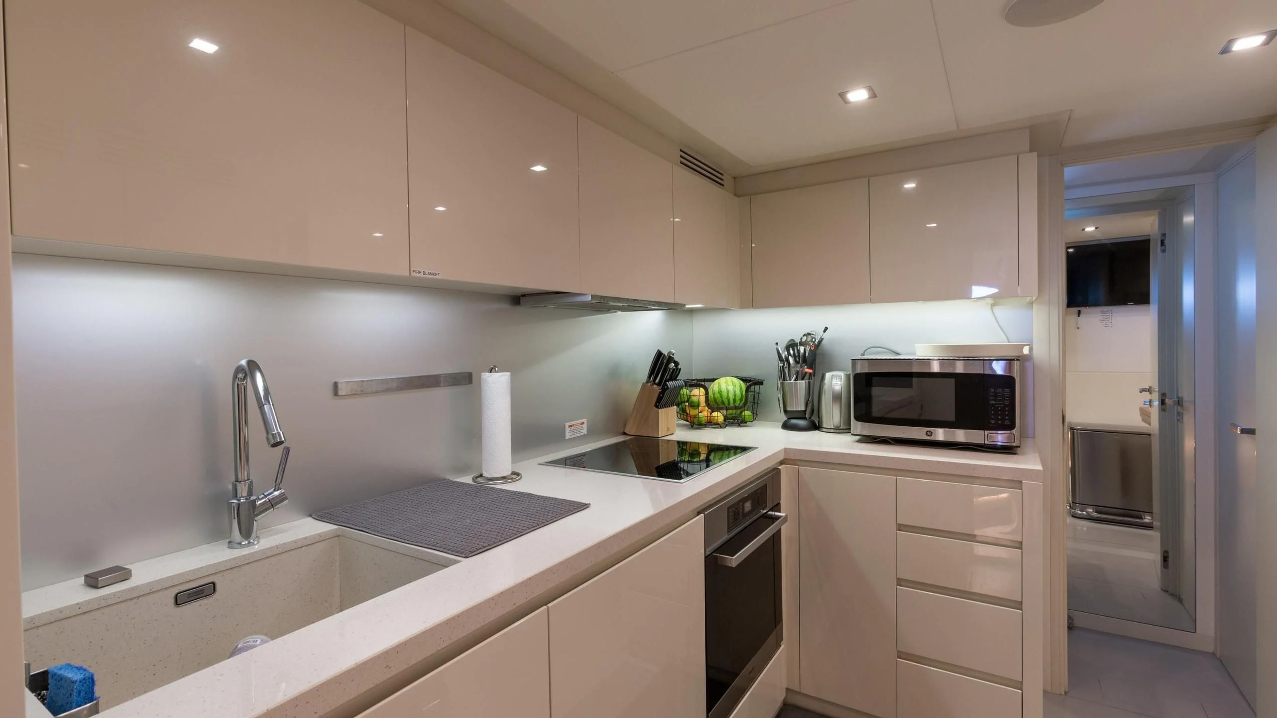 a kitchen with white cabinets aboard VIXEN Yacht for Sale