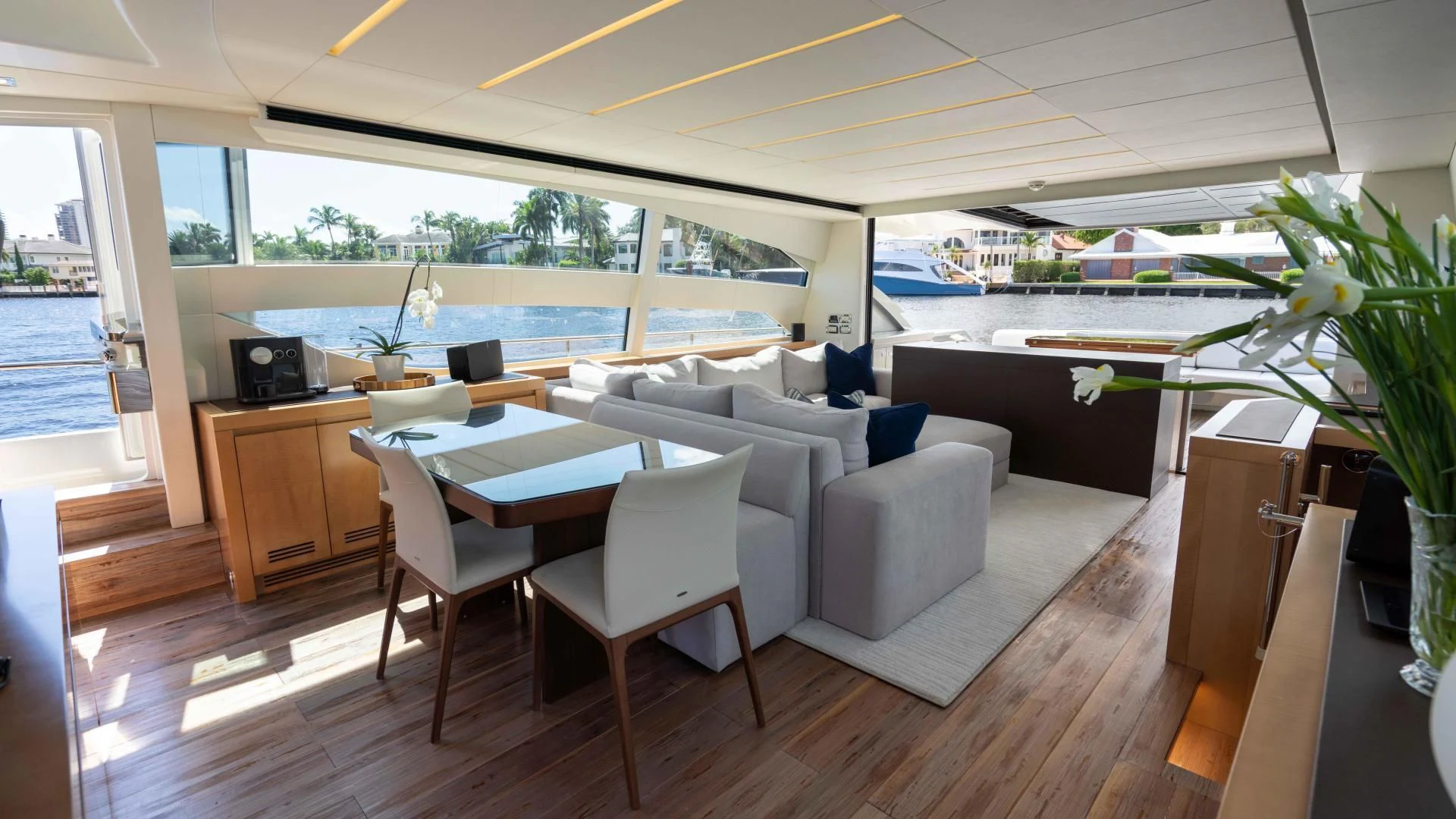 a room with a table chairs and plants aboard VIXEN Yacht for Sale