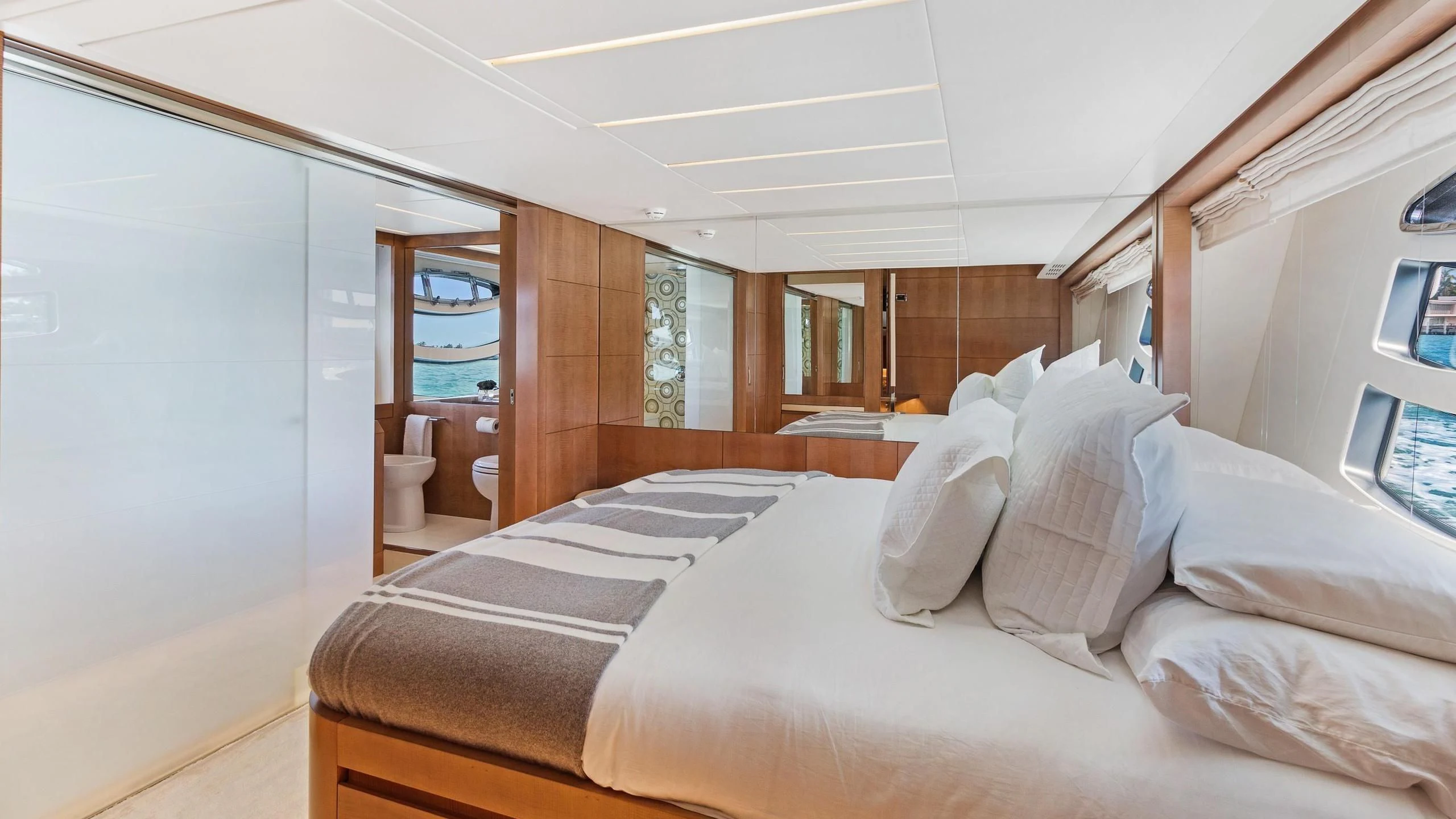 a room with a bed and a window aboard VIXEN Yacht for Sale