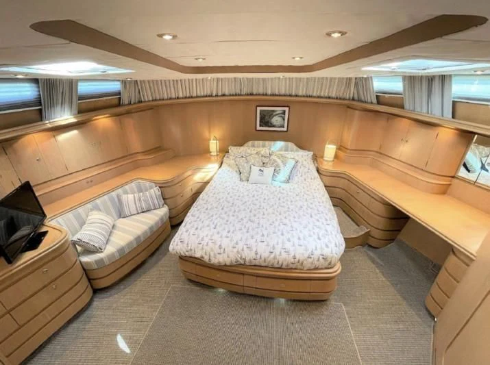 a room with a bed and a couch aboard BLUE LEGEND Yacht for Sale