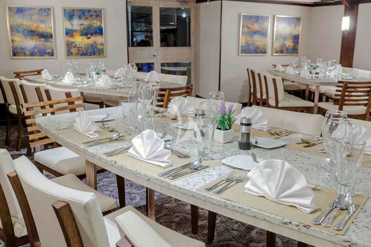 a table set for a formal dinner aboard EVOLUTION Yacht for Sale