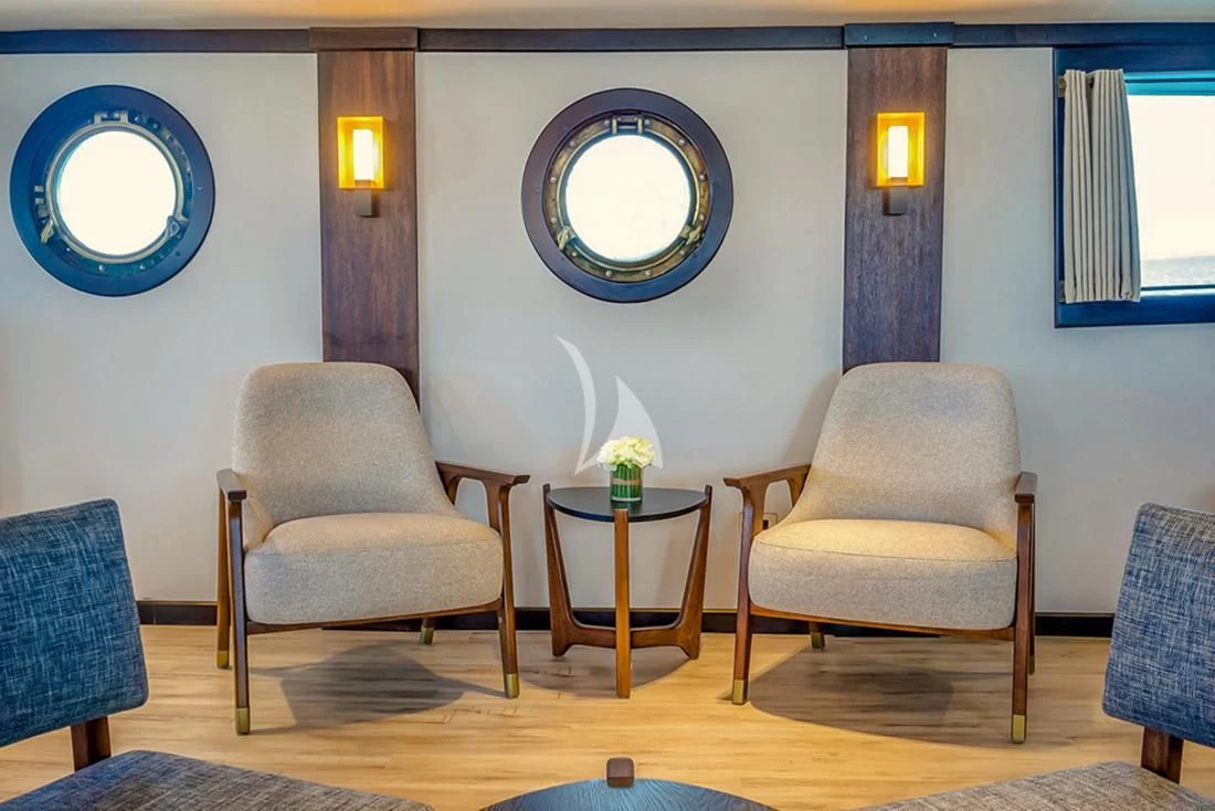 a room with chairs and a table aboard EVOLUTION Yacht for Sale