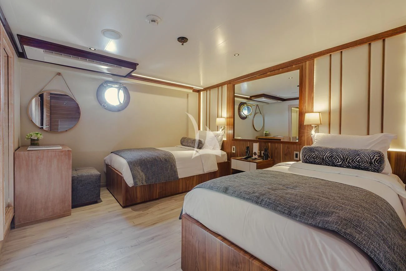 a room with two beds aboard EVOLUTION Yacht for Sale