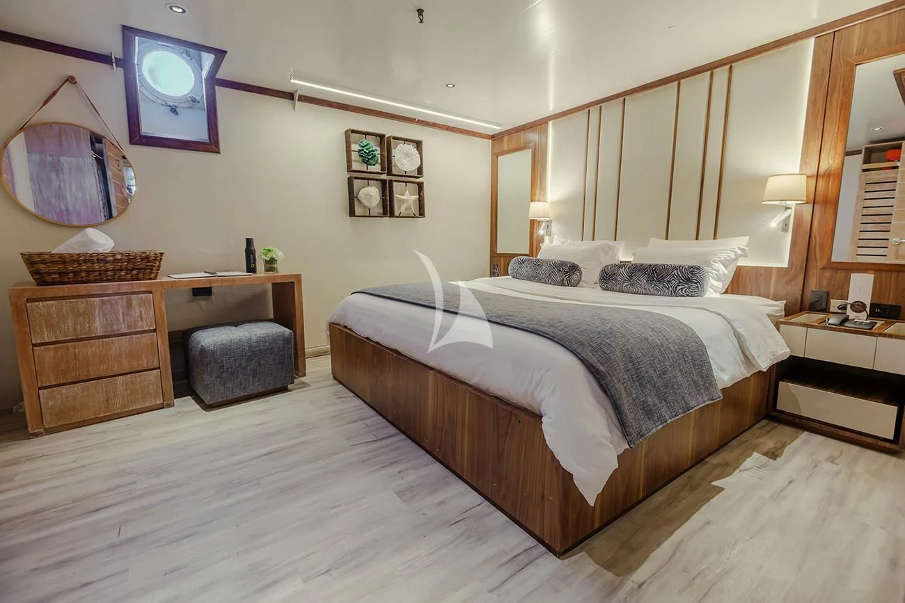 a bedroom with a large bed aboard EVOLUTION Yacht for Sale
