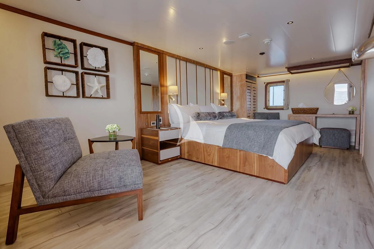 a large bedroom with a large bed aboard EVOLUTION Yacht for Sale