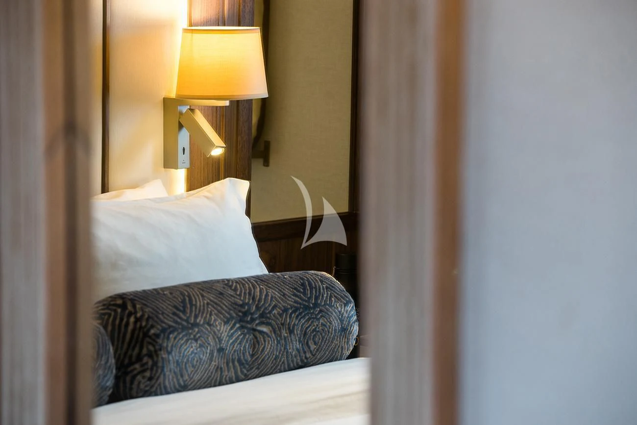 a lamp on a bed aboard EVOLUTION Yacht for Sale