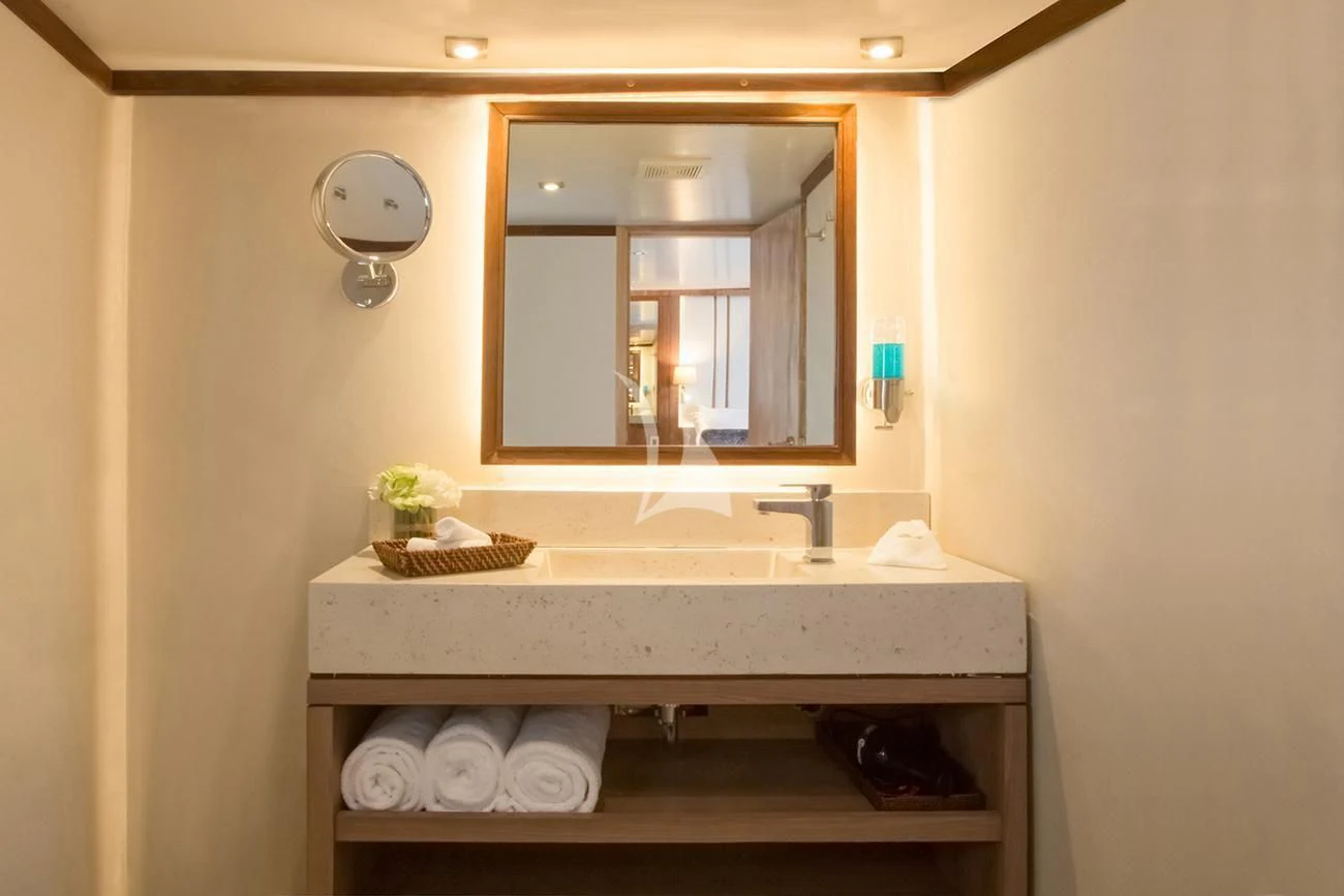 a bathroom with a mirror and a sink aboard EVOLUTION Yacht for Sale