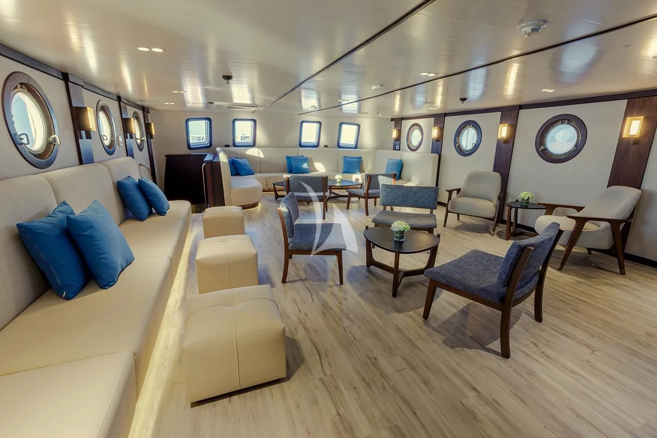 a room with a couch and chairs aboard EVOLUTION Yacht for Sale