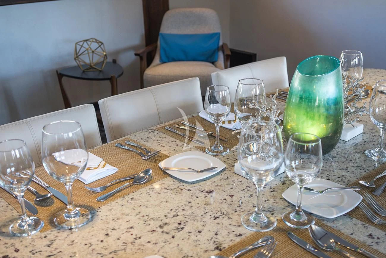 a table with empty wine glasses aboard EVOLUTION Yacht for Sale