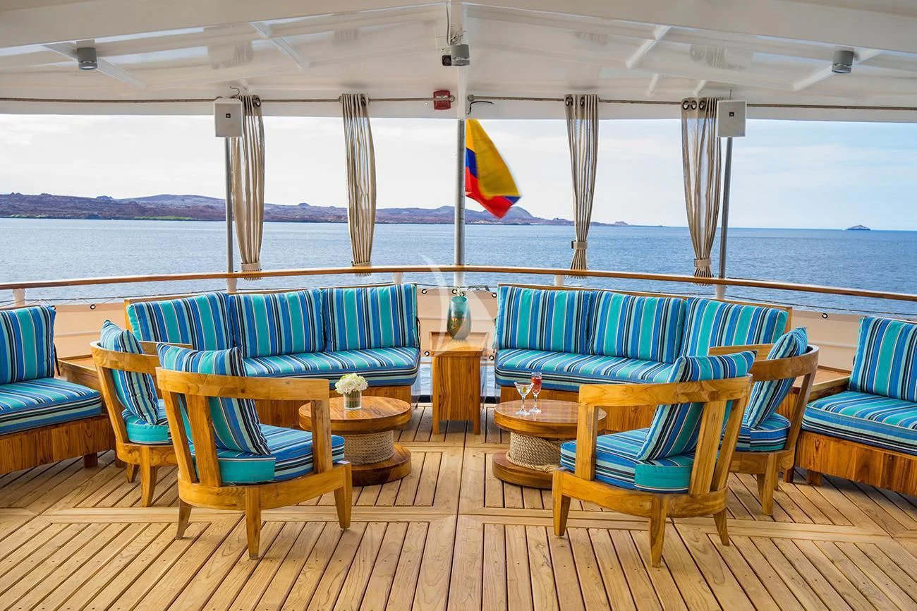 a deck with chairs and tables aboard EVOLUTION Yacht for Sale