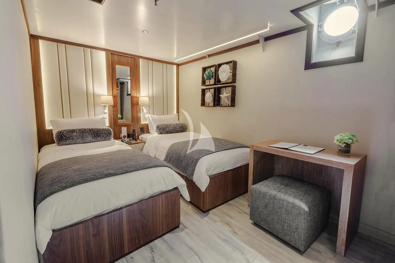 a room with two beds aboard EVOLUTION Yacht for Sale