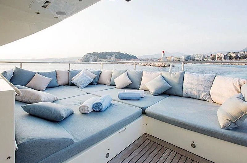 a couch with pillows on it aboard LIBERDADE Yacht for Sale