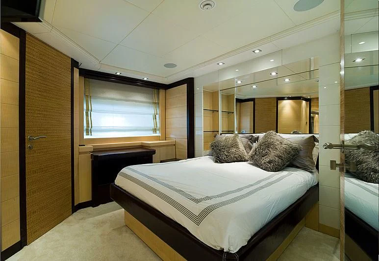 a room with a bed and a mirror aboard LIBERDADE Yacht for Sale