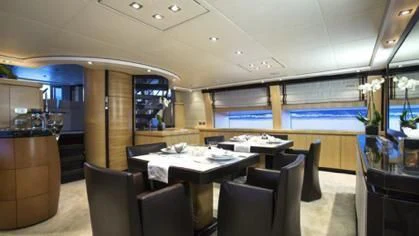 a room with tables and chairs aboard LIBERDADE Yacht for Sale