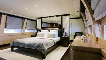 a bedroom with a bed and a desk aboard LIBERDADE Yacht for Sale