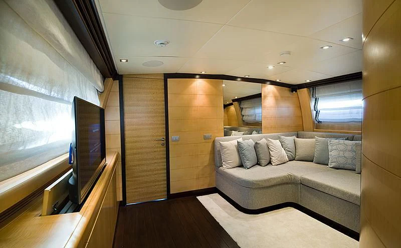 a living room with a couch and a tv aboard LIBERDADE Yacht for Sale