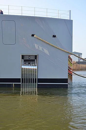 a large white building with a ladder in the water aboard MOONRISE Yacht for Sale