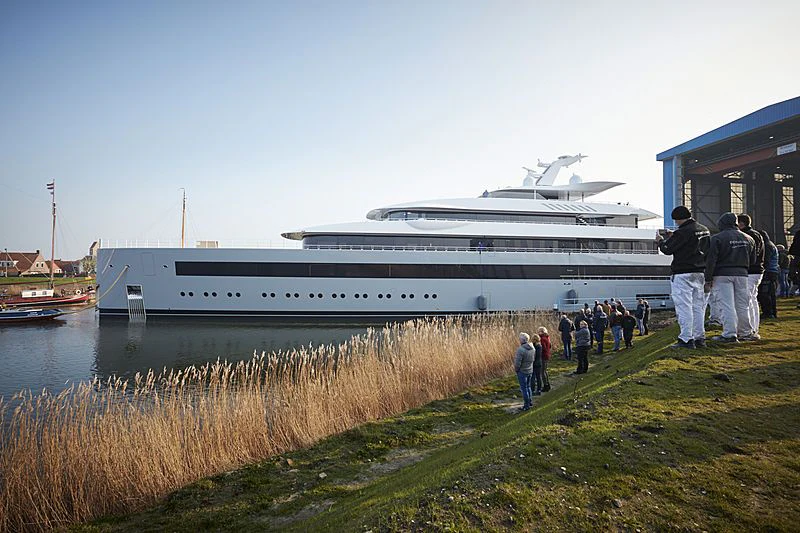 a group of people standing next to a large ship aboard MOONRISE Yacht for Sale