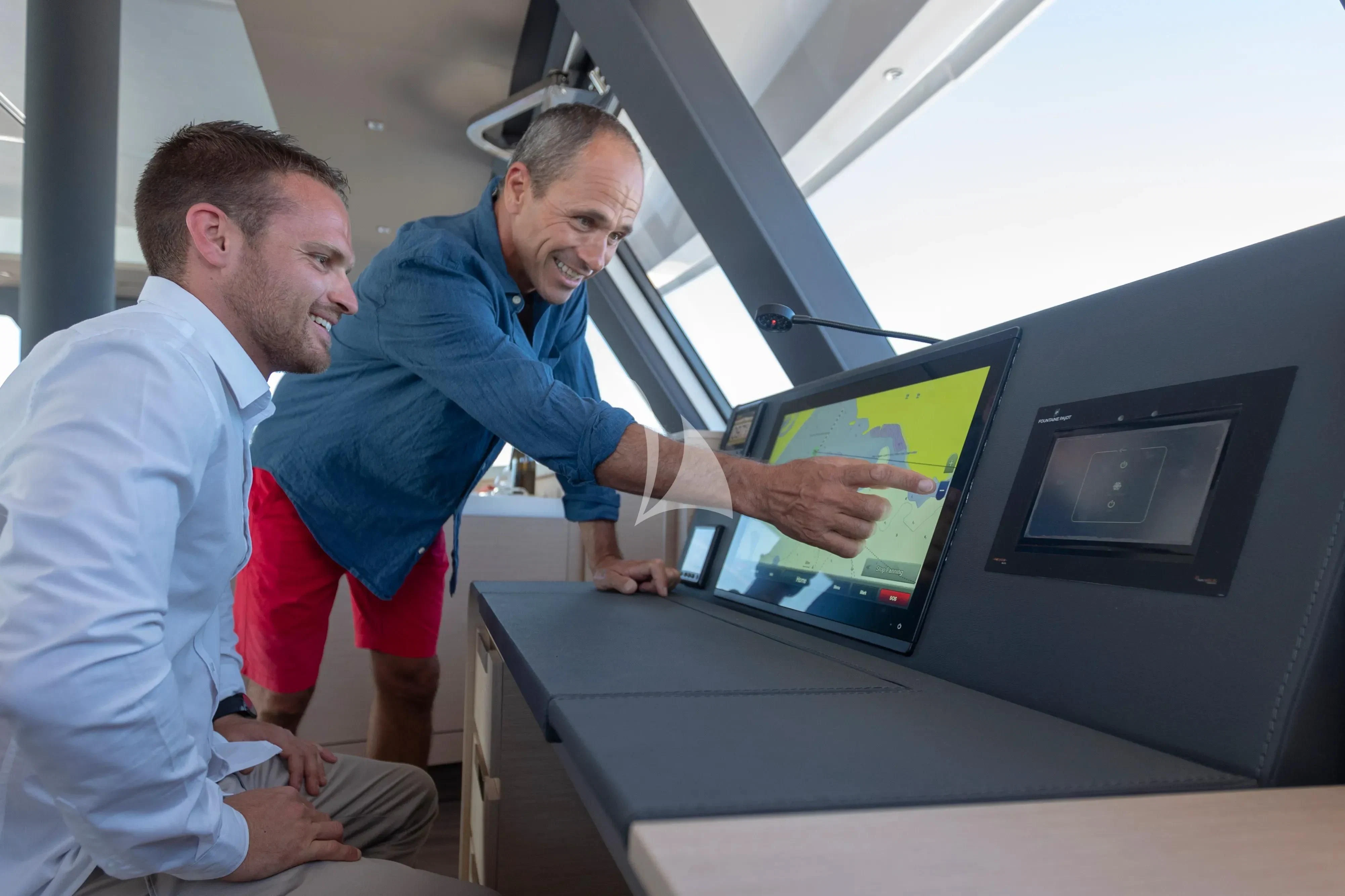 men looking at a computer aboard STEPHANIE Yacht for Charter