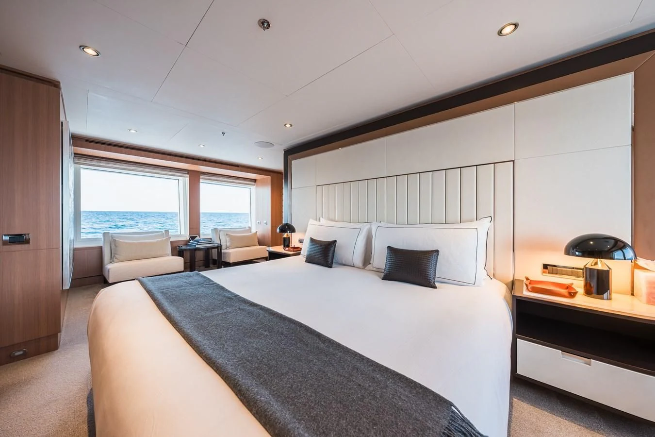 a bedroom with a bed and a desk aboard GO Yacht for Sale