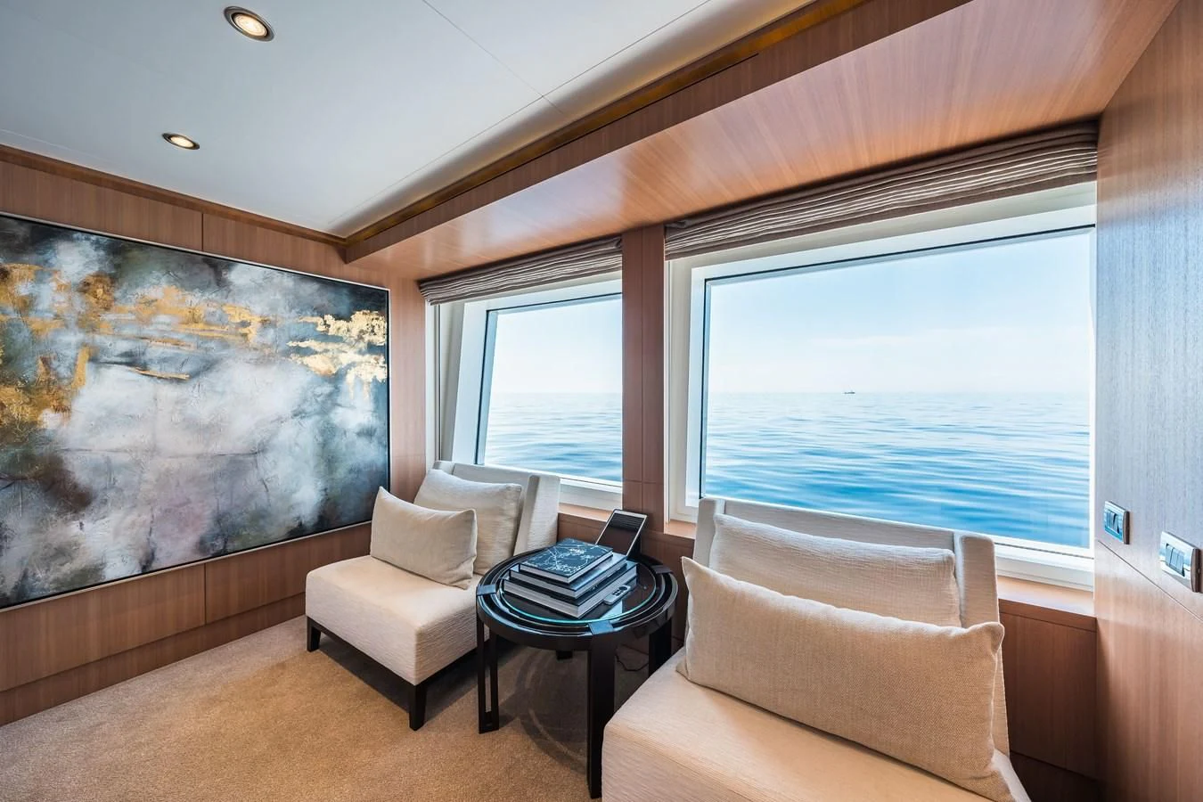 a living room with a large painting aboard GO Yacht for Sale