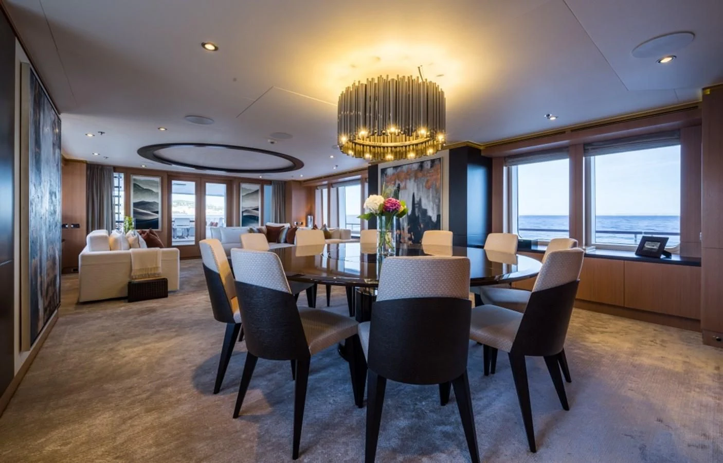a large room with chairs and a chandelier aboard GO Yacht for Sale