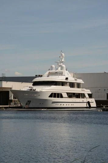 a large white boat in a harbor aboard GO Yacht for Sale