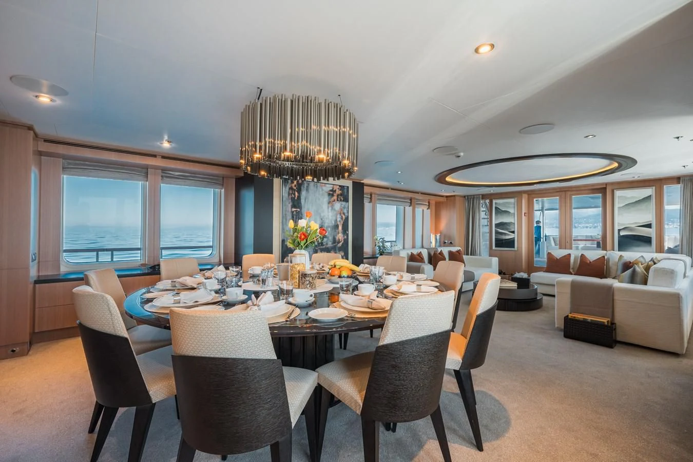 a large dining room with a large chandelier aboard GO Yacht for Sale