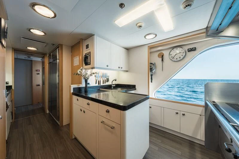 a kitchen with white cabinets aboard GO Yacht for Sale