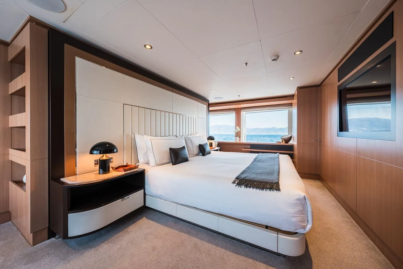 a bedroom with a bed and a desk aboard GO Yacht for Sale