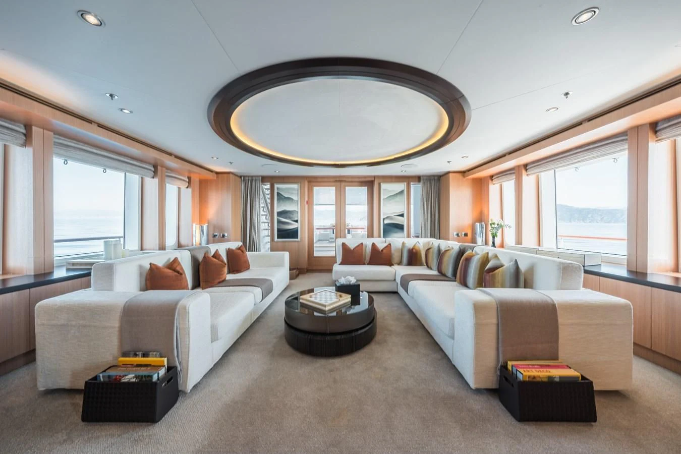 a living room with a large chandelier aboard GO Yacht for Sale