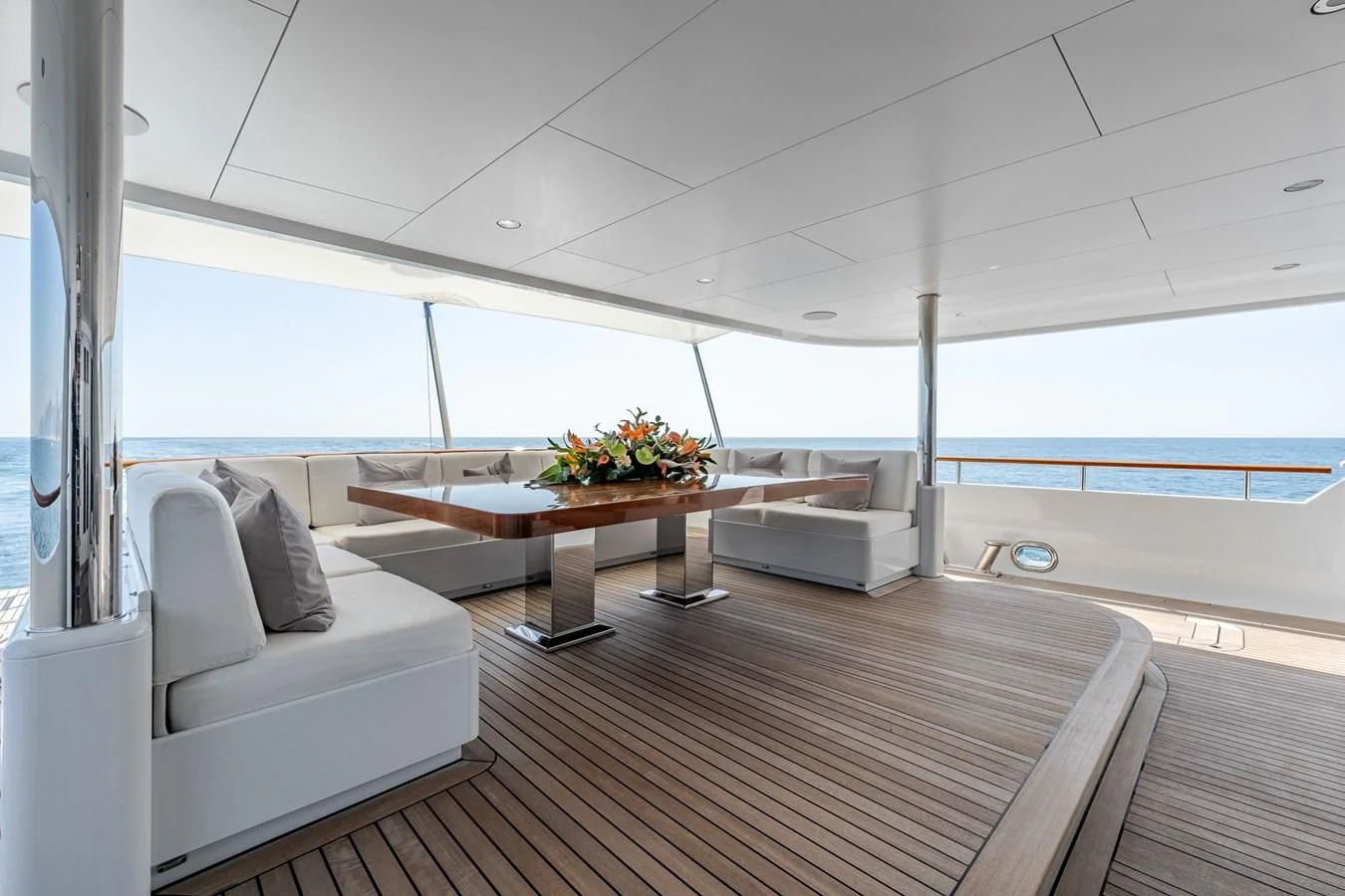 a room with a table and couch aboard GO Yacht for Sale