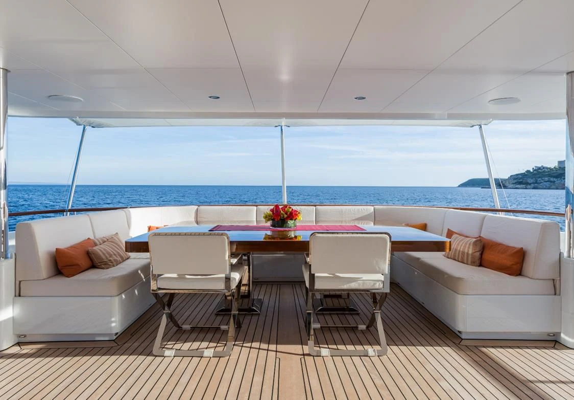 a room with a table and chairs aboard GO Yacht for Sale