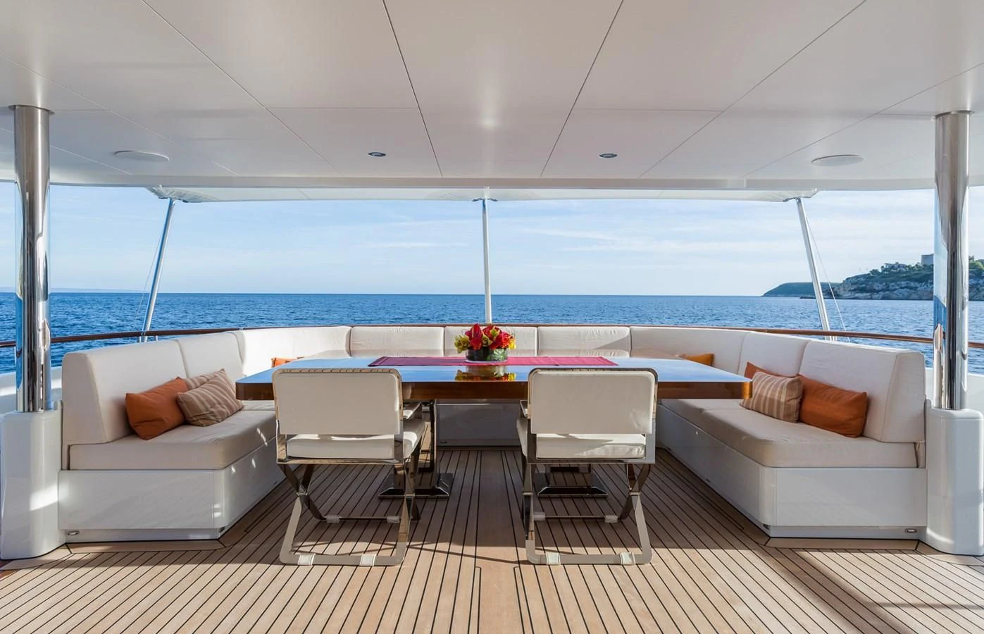 a room with a table chairs and a couch aboard GO Yacht for Sale